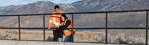 IR-2-workers-taking-wastewater-samples-outside